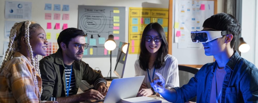 A team of developers working with virtual reality glasses during business meetings.